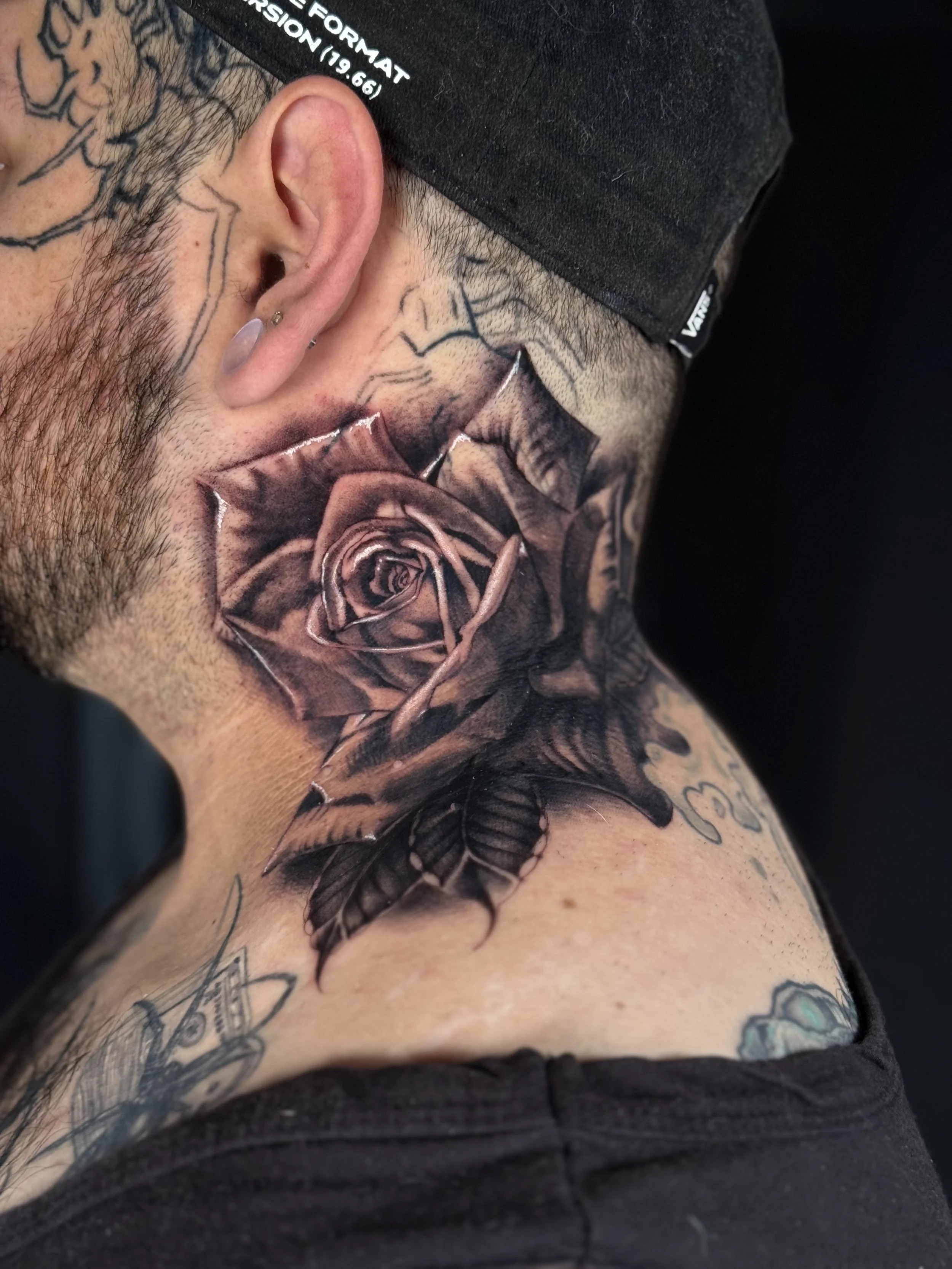 Neck rose tattoo