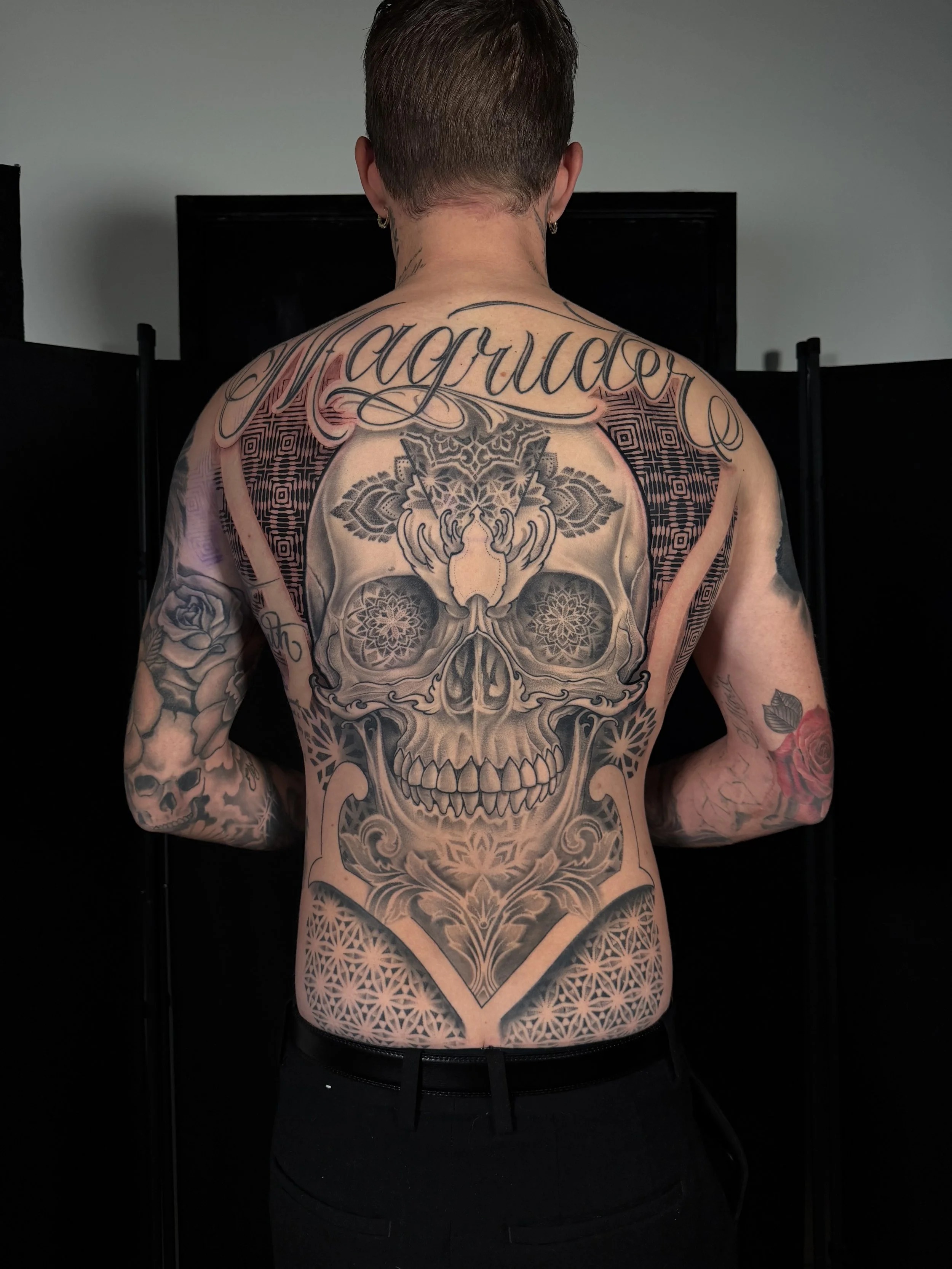 Ornamental skull full-back tattoo at Committed Arts